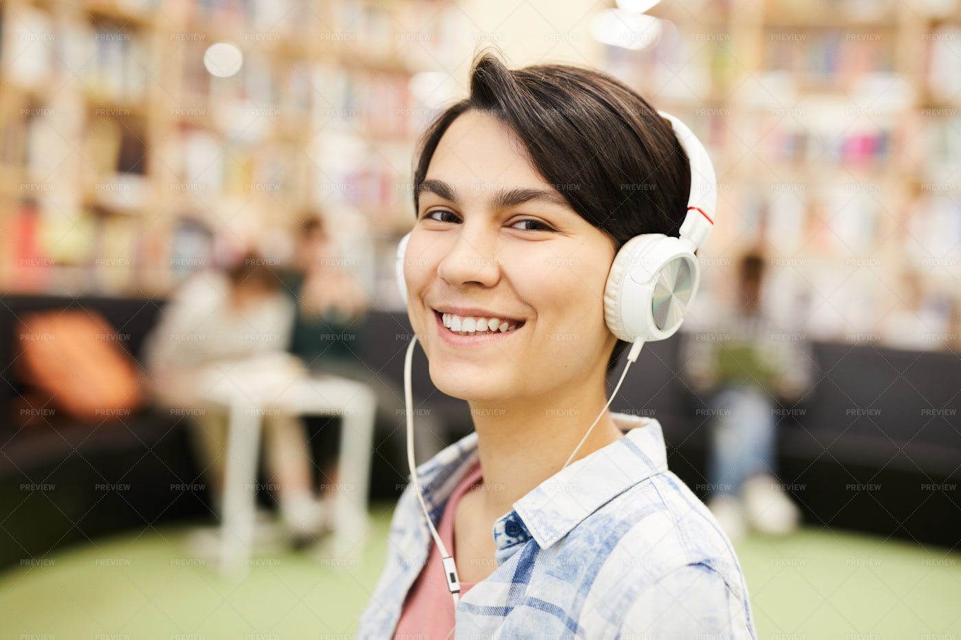 Smiling Girl Listening To Audiobook...: Stock Photos