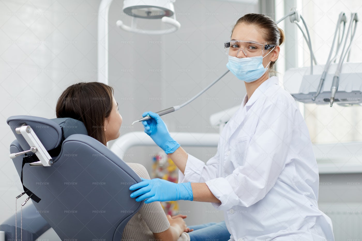 Female Dentist Working In Clinic: Stock Photos
