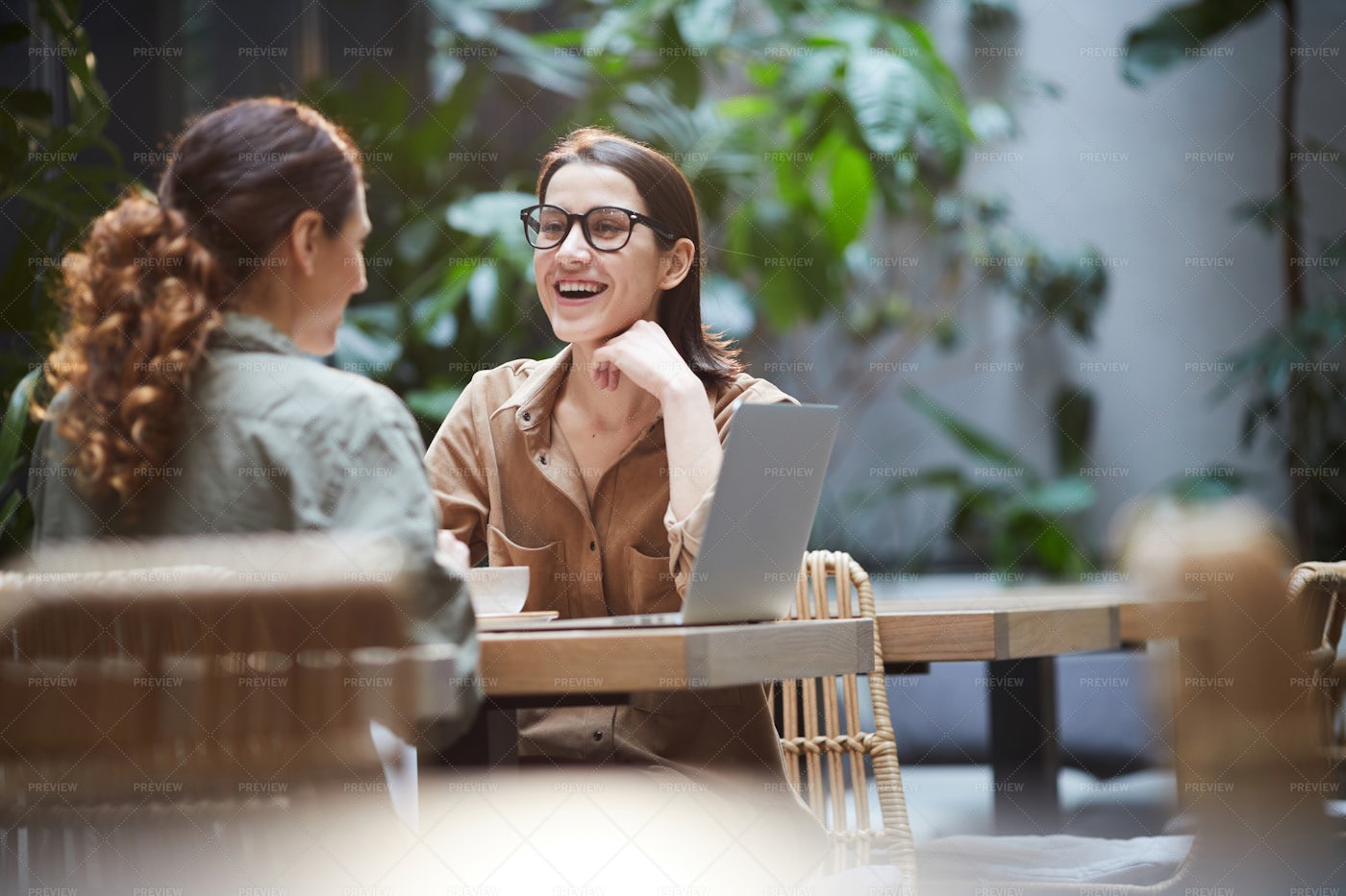 Woman Laughing During Lunch With...: Stock Photos