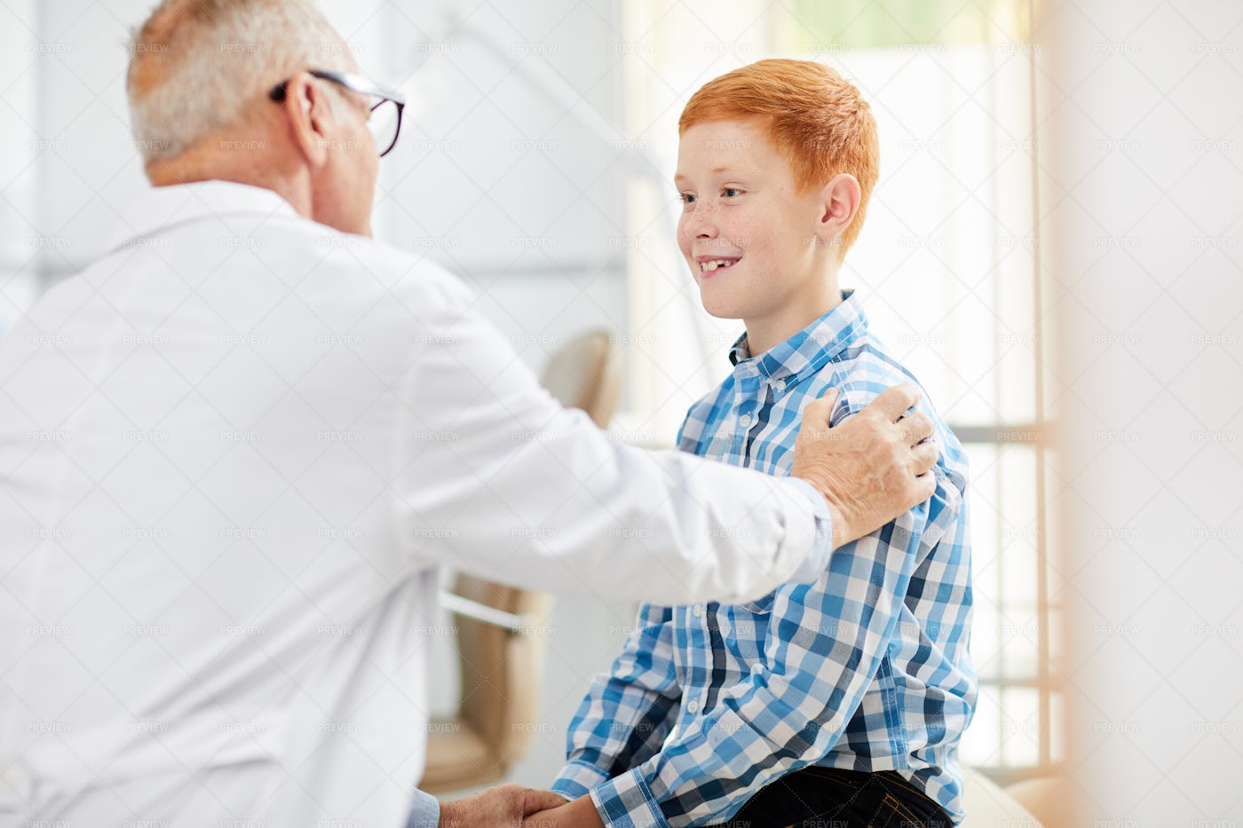 Friendly Doctor Consulting Child: Stock Photos