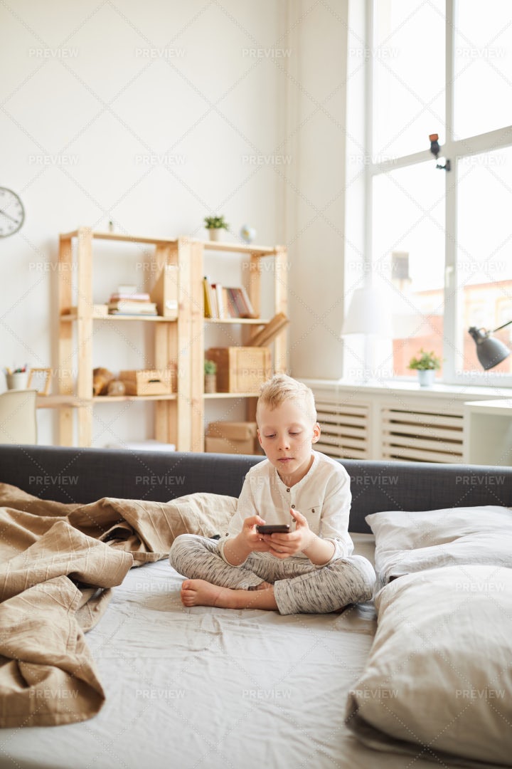 Gadget-addicted Kid At Home: Stock Photos