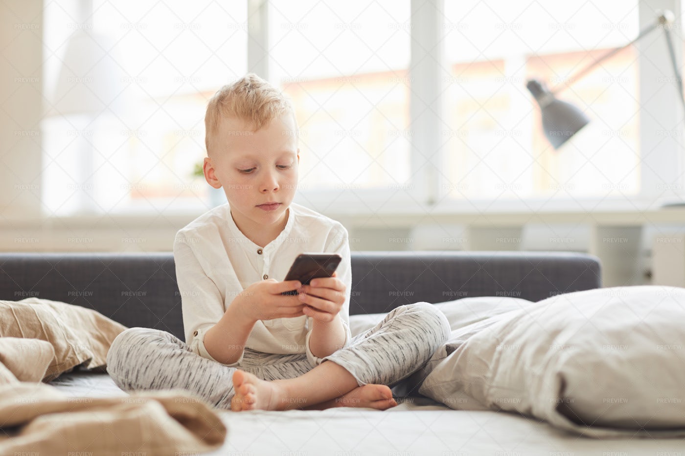 Boy Using Smartphone In Morning: Stock Photos