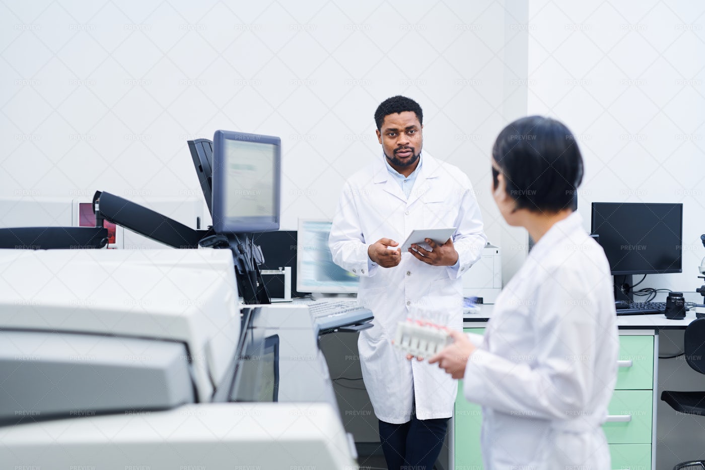 Black Doctor Talking To Colleague...: Stock Photos