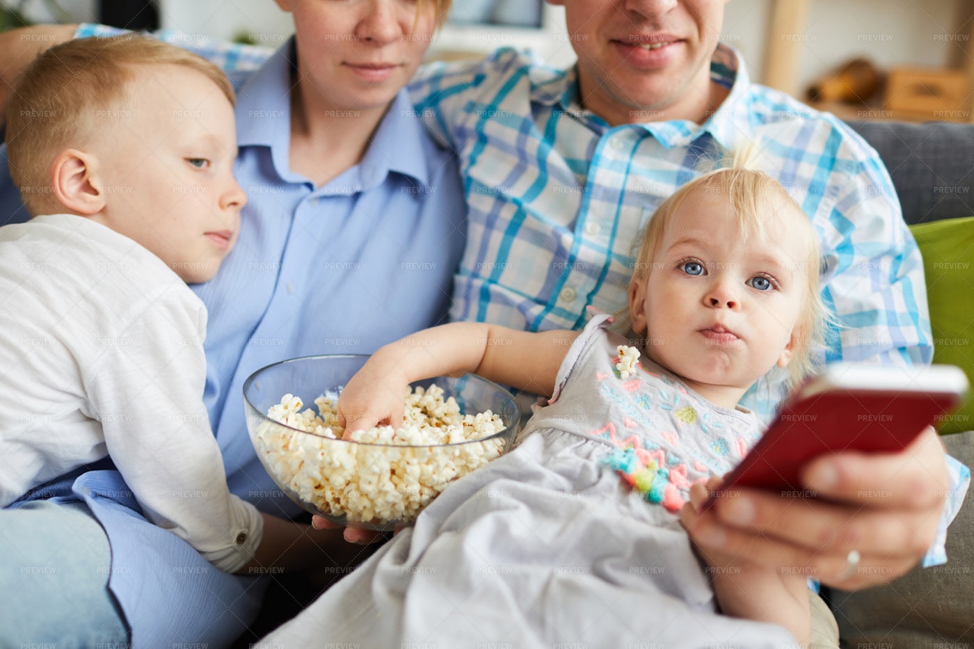 Family Watching Tv And Eating...: Stock Photos