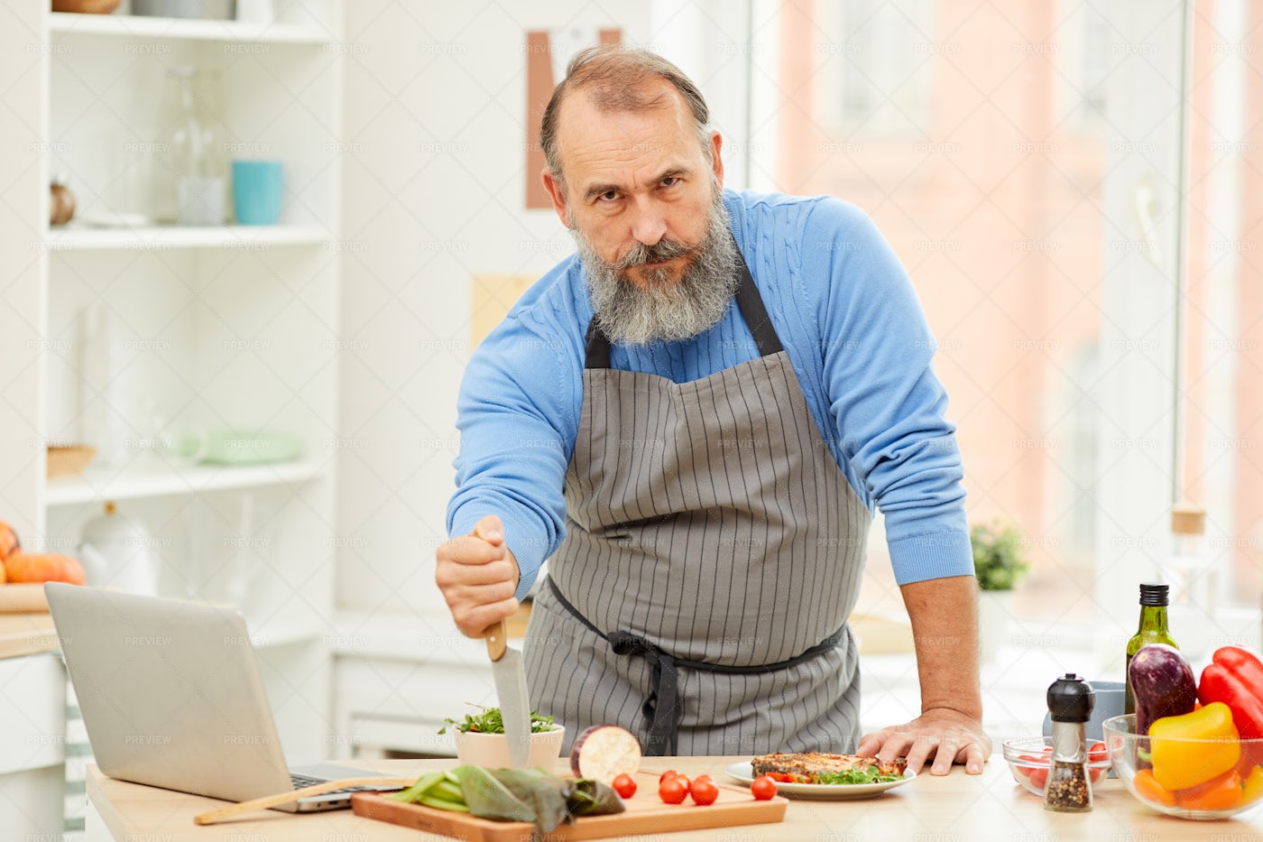 Tough Senior Man Cooking: Stock Photos