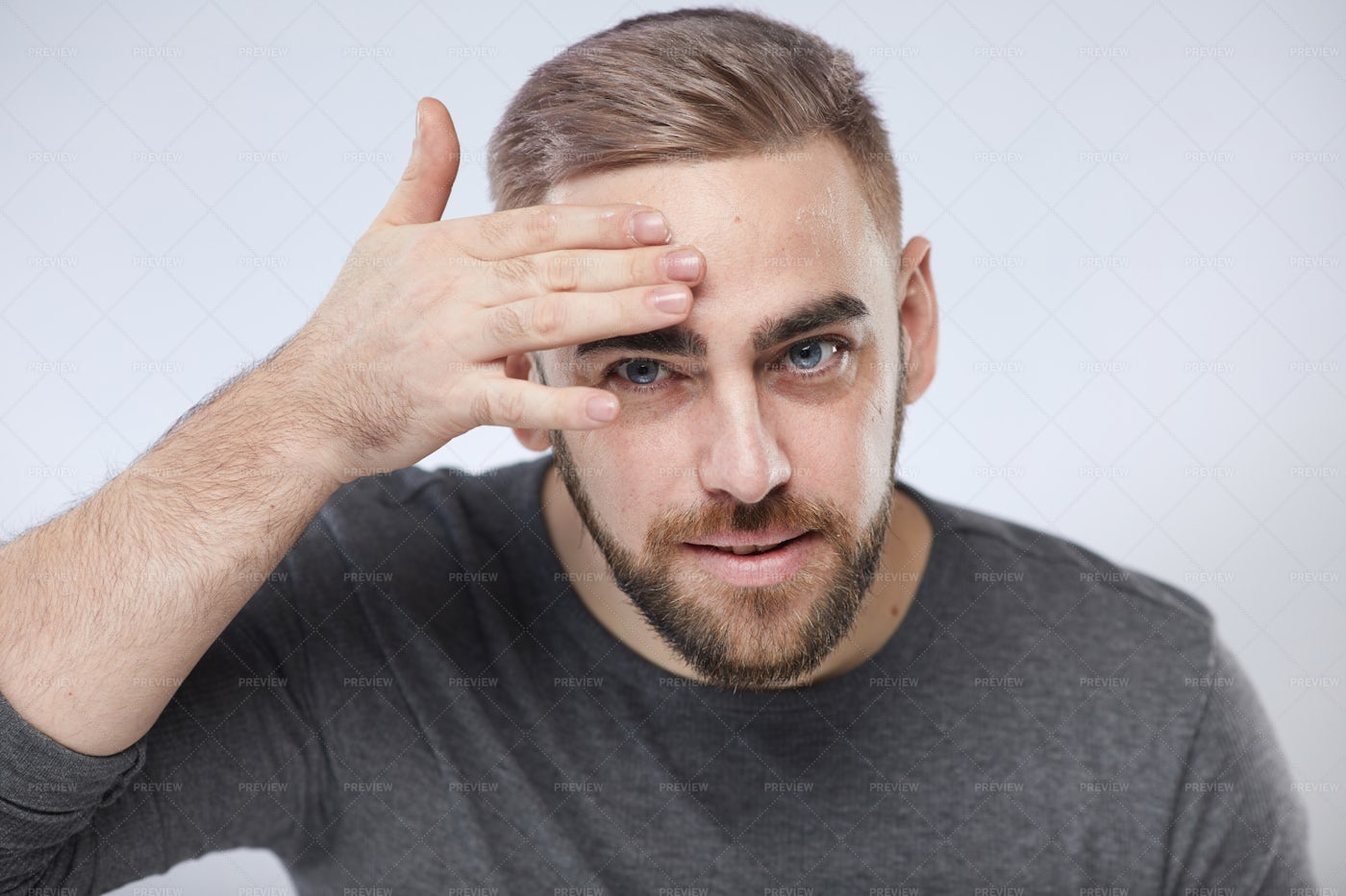 Young Man Applying Face Cream: Stock Photos