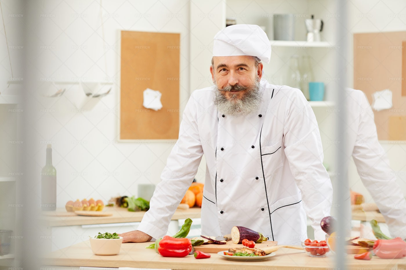 Senior Chef Posing In Kitchen: Stock Photos