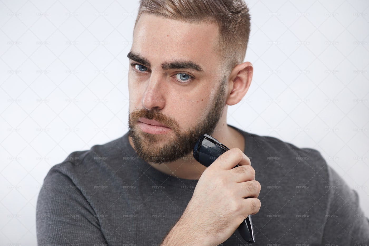Young Man Trimming Beard: Stock Photos