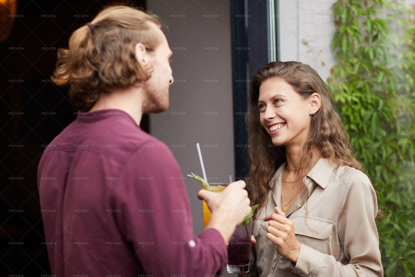 Young Couple Chatting Outdoors By...: Stock Photos