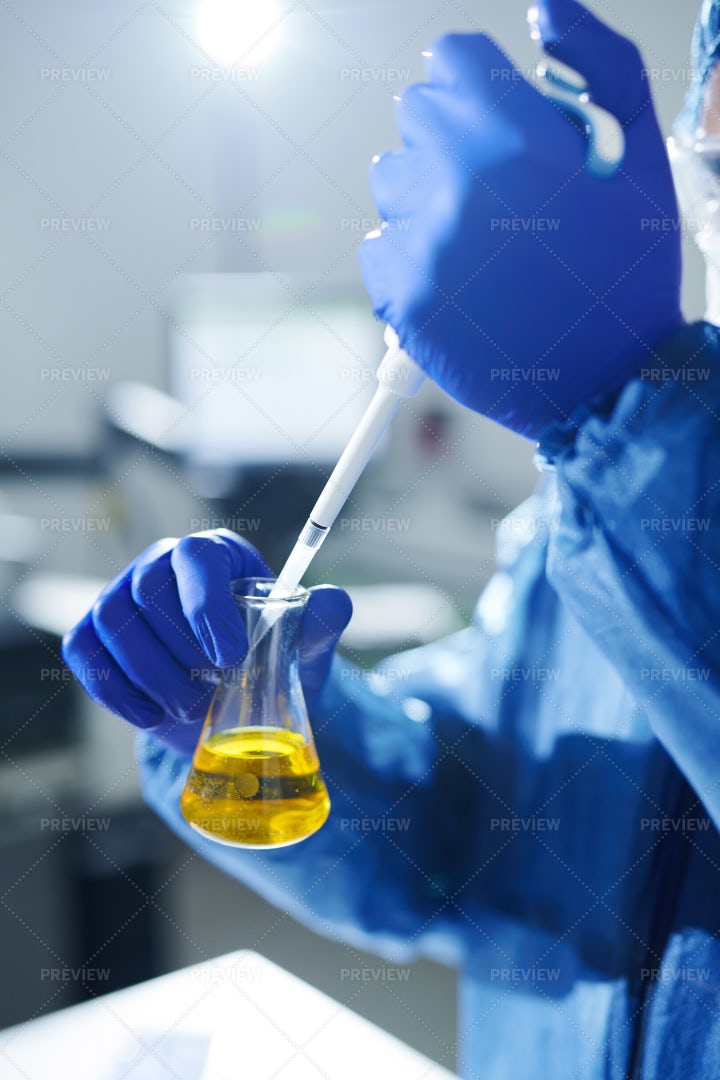 Dropping Reagent Into Flask With...: Stock Photos
