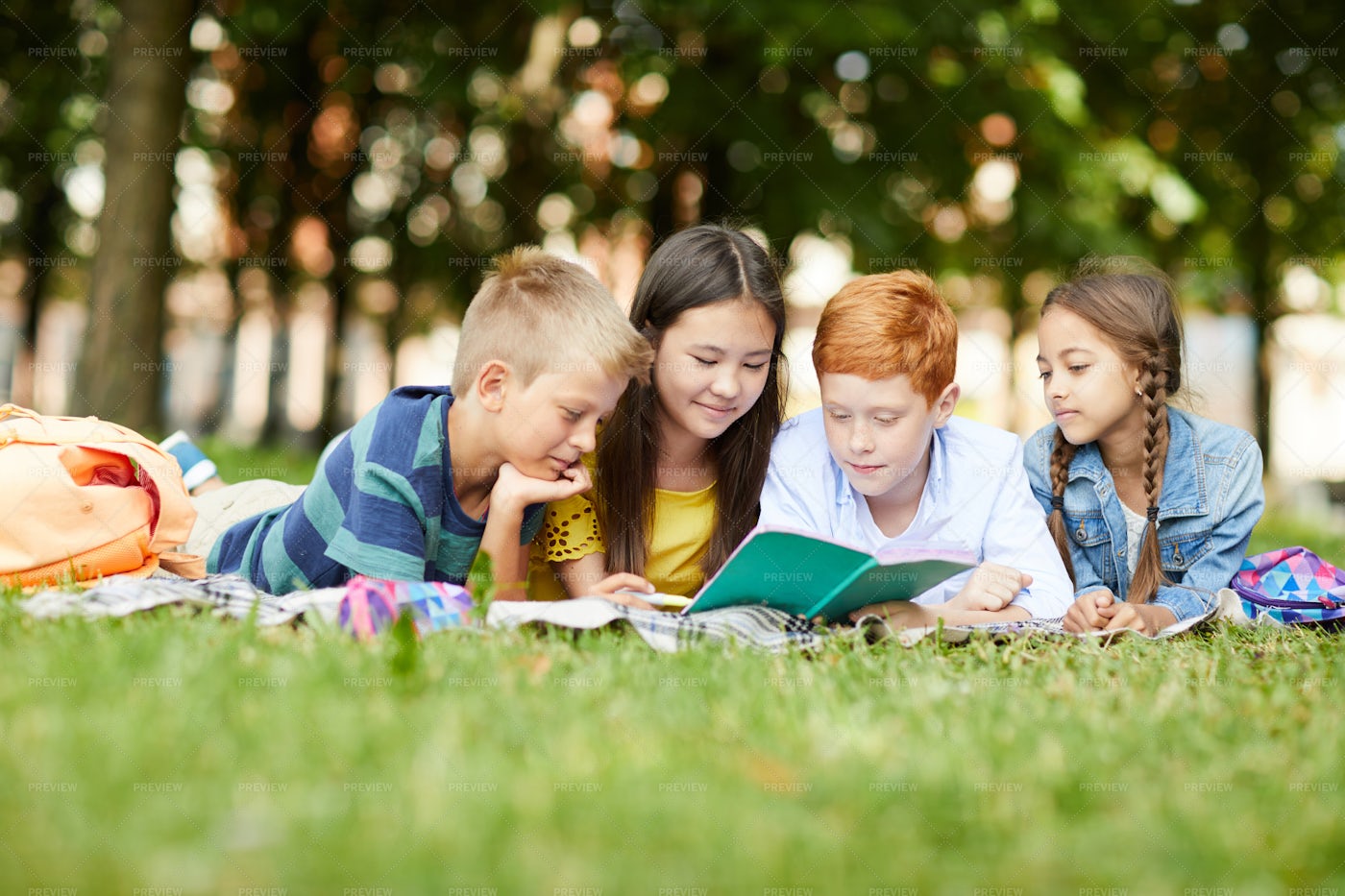 Reading Together In Park: Stock Photos