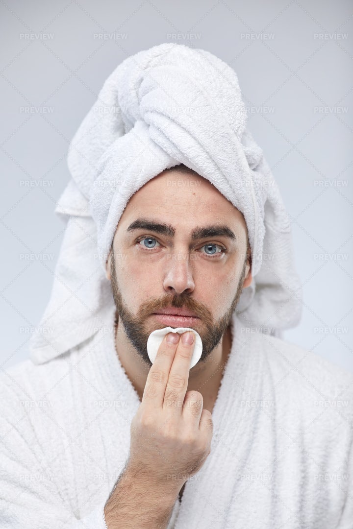 Caucasian Man Using Cotton Pad: Stock Photos