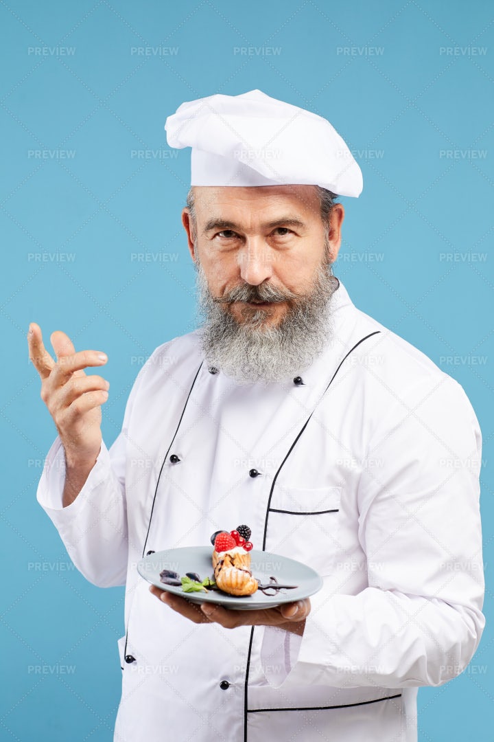 Senior Chef Presenting Dessert On...: Stock Photos