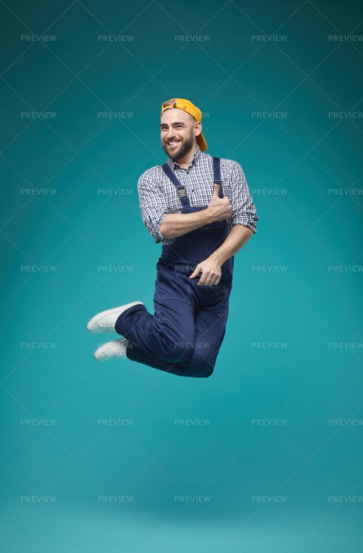Joyful Worker Jumping Studio Shot: Stock Photos