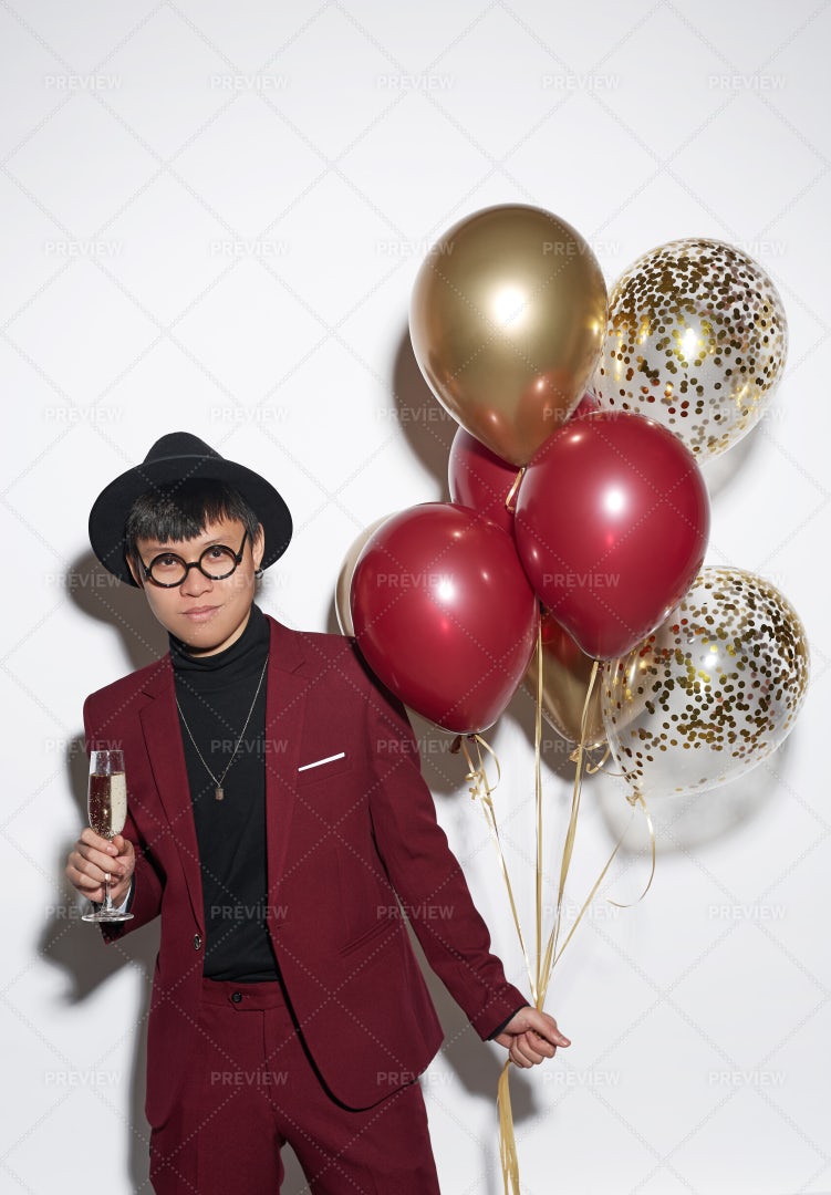 Young Asian Man Holding Balloons At...: Stock Photos