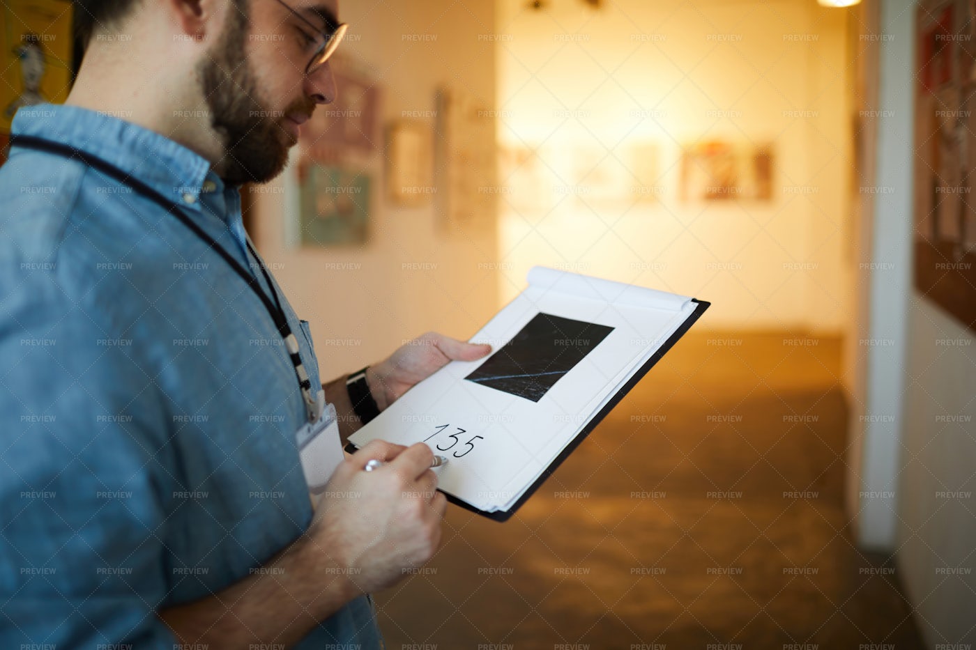 Man Appraising Pictures: Stock Photos