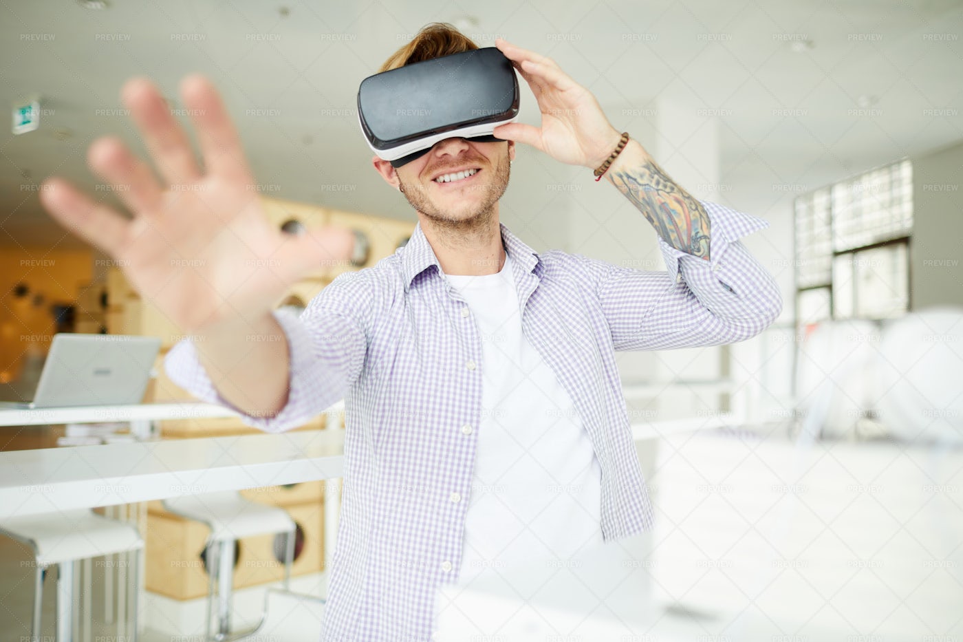 Curious Hipster Guy Immersed Into...: Stock Photos