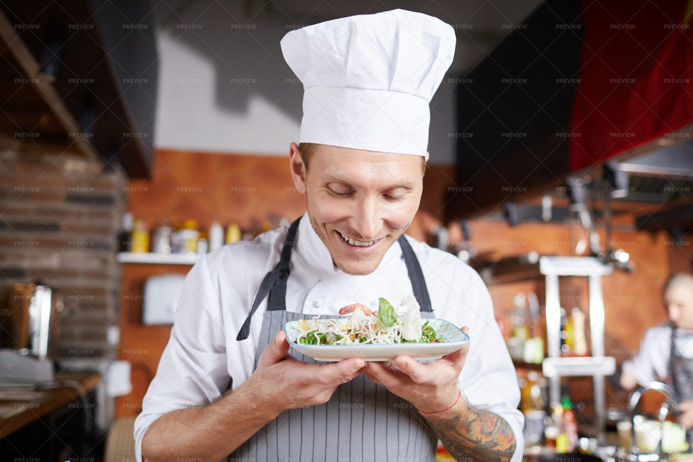 Smiling Chef Presenting Beautiful...: Stock Photos
