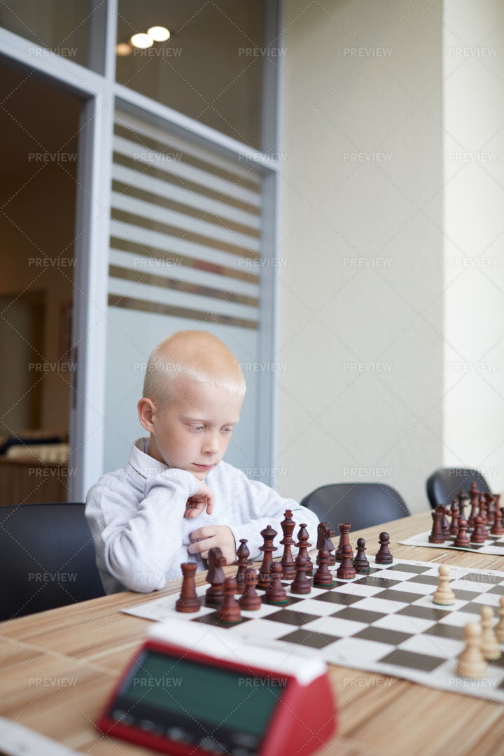 Boy Analyzing Chess Game: Stock Photos