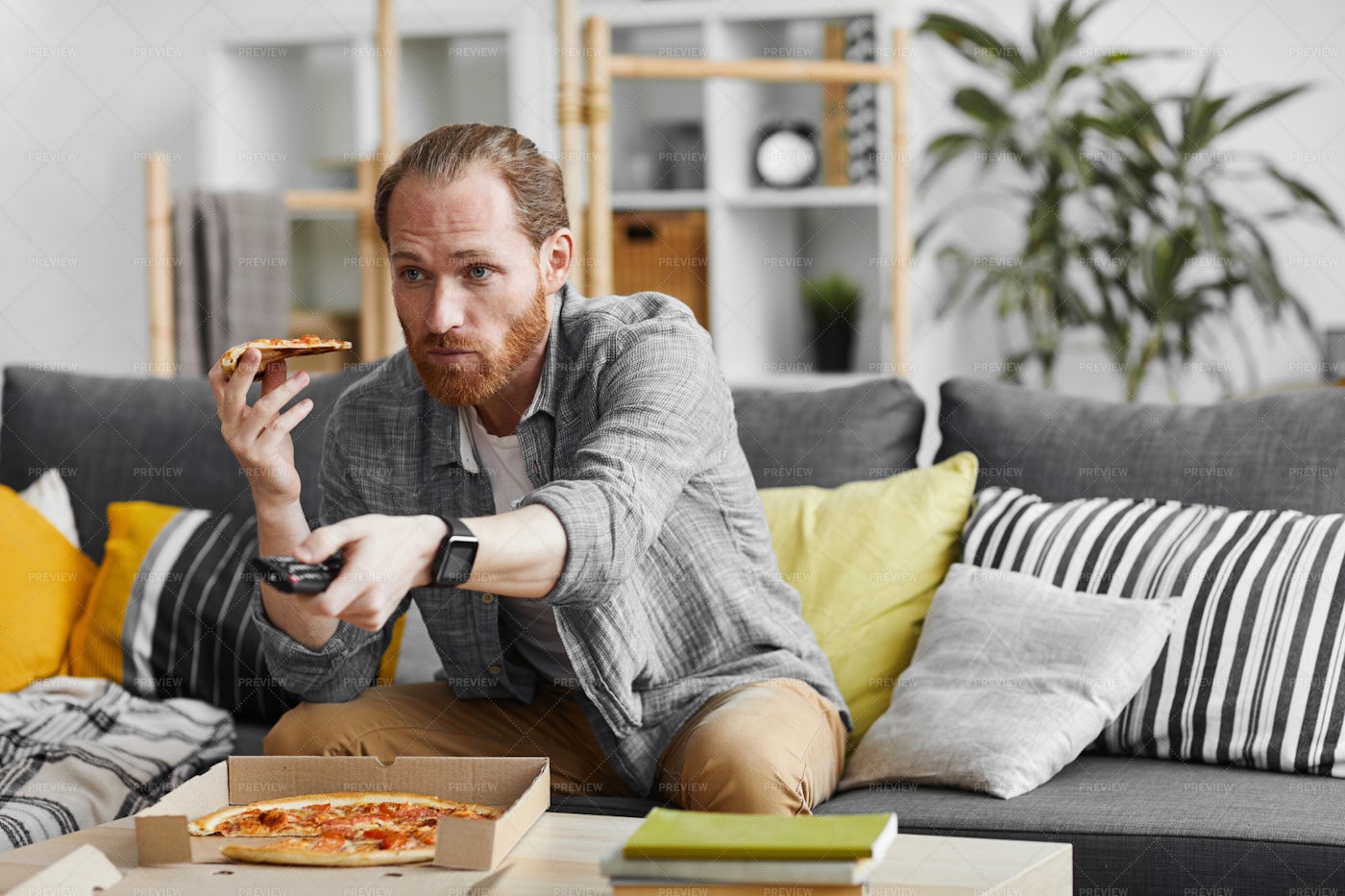 Single Man Eating Pizza While...: Stock Photos