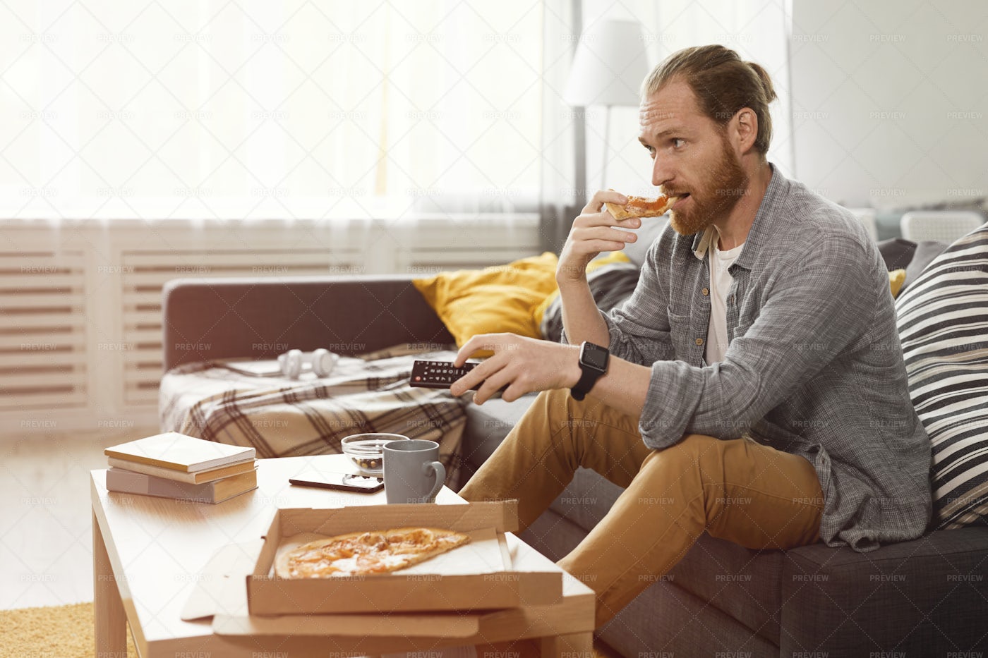 Man Binge Watching TV: Stock Photos