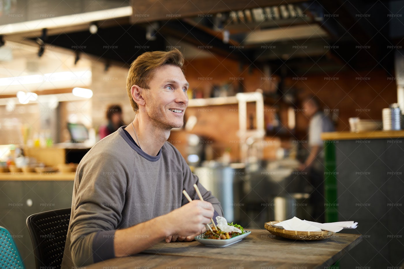 Smiling Man Enjoying Asian Food: Stock Photos