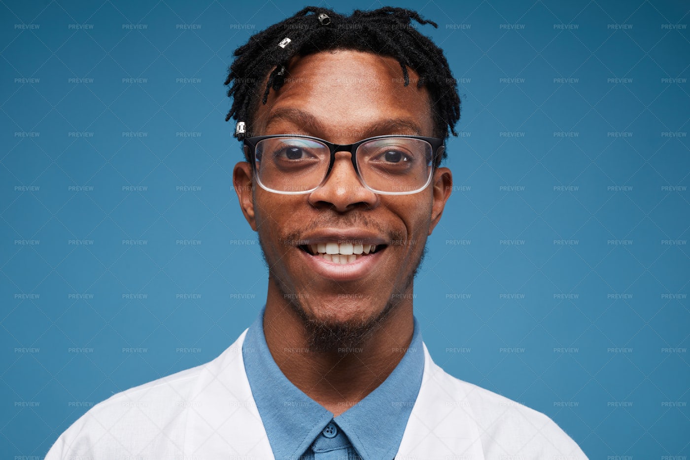 Smiling African Doctor On Blue: Stock Photos