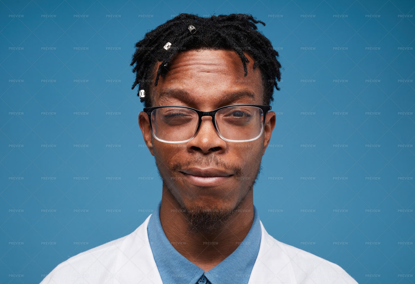 Young African Doctor Posing On Blue: Stock Photos