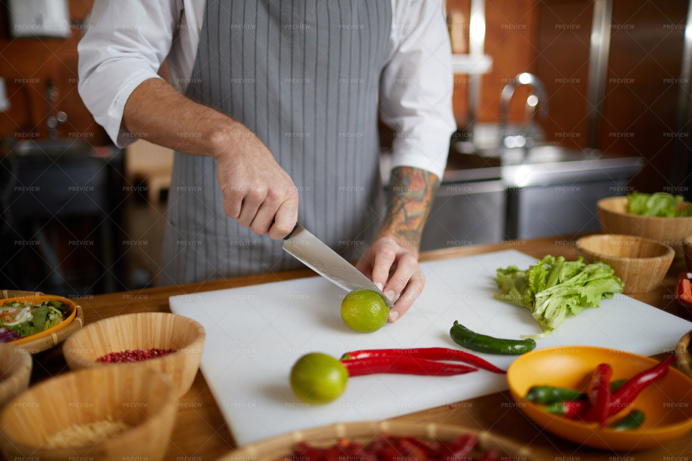Chef Cutting Citrus In Kitchen: Stock Photos