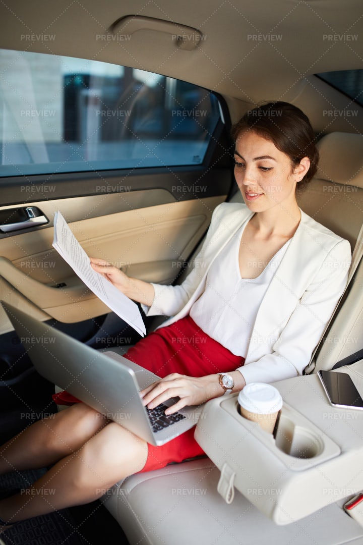 Businesswoman Working In Taxi: Stock Photos