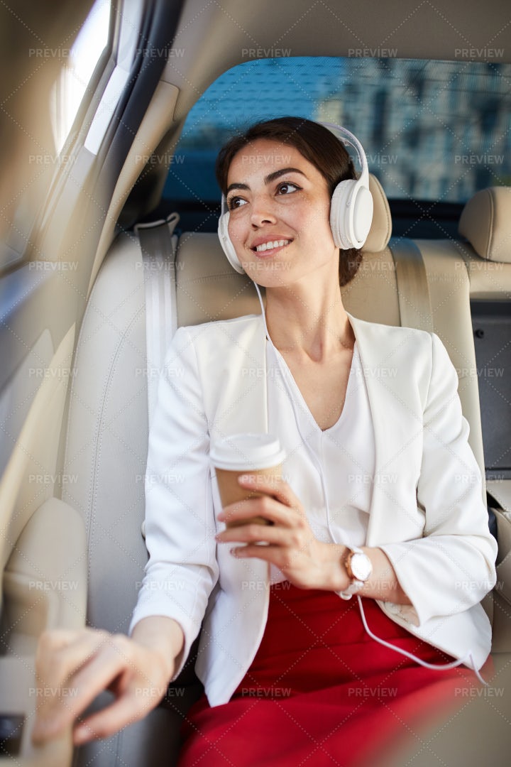 Smiling Woman Listening To Music In...: Stock Photos