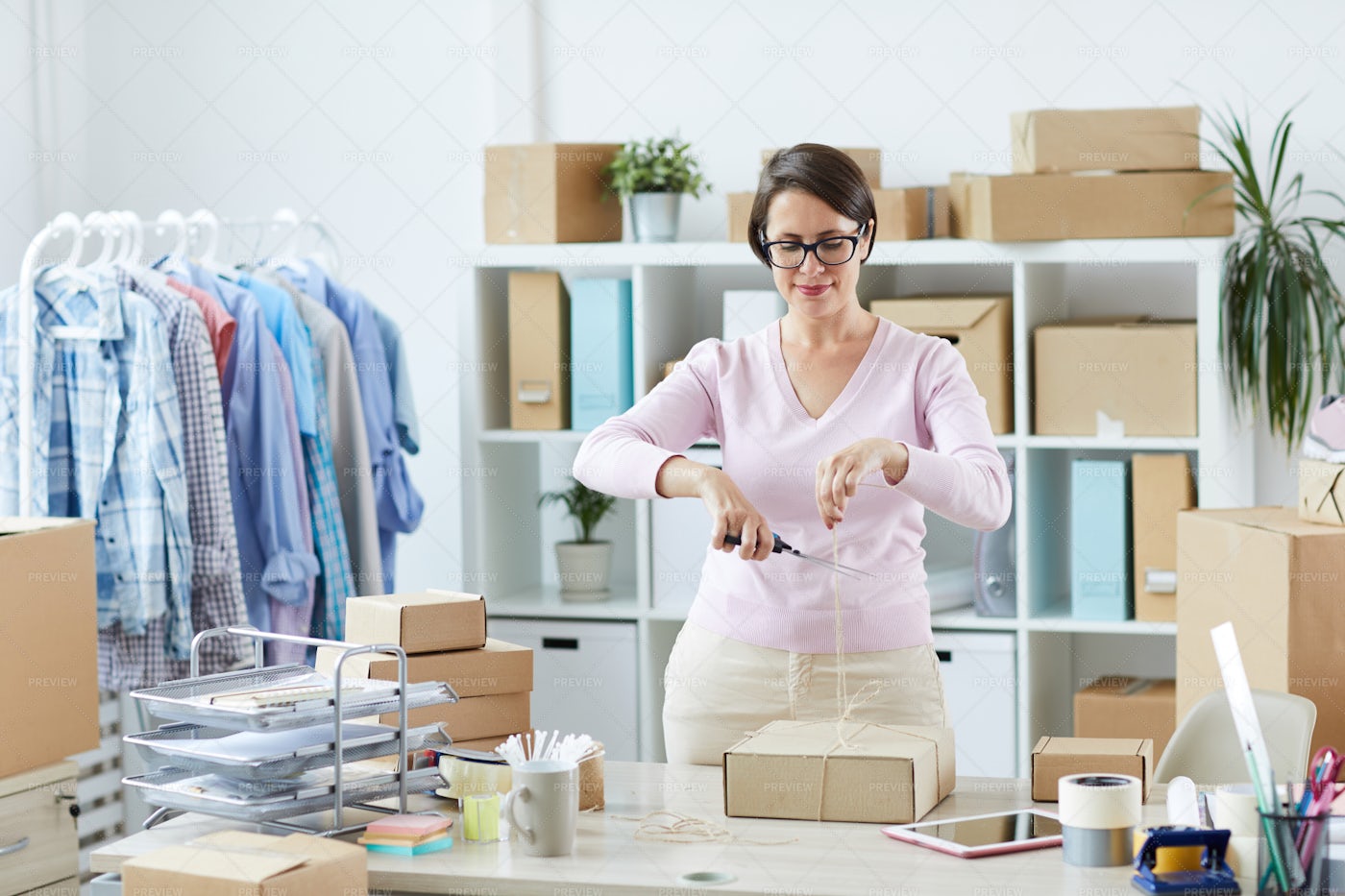 Young Woman Cutting Thread On Top...: Stock Photos
