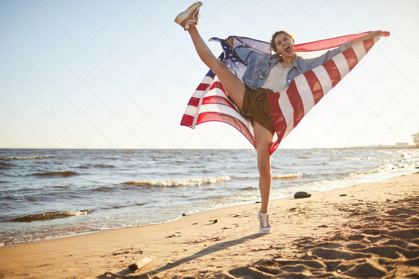 Excited Flexible Woman With US Flag: Stock Photos