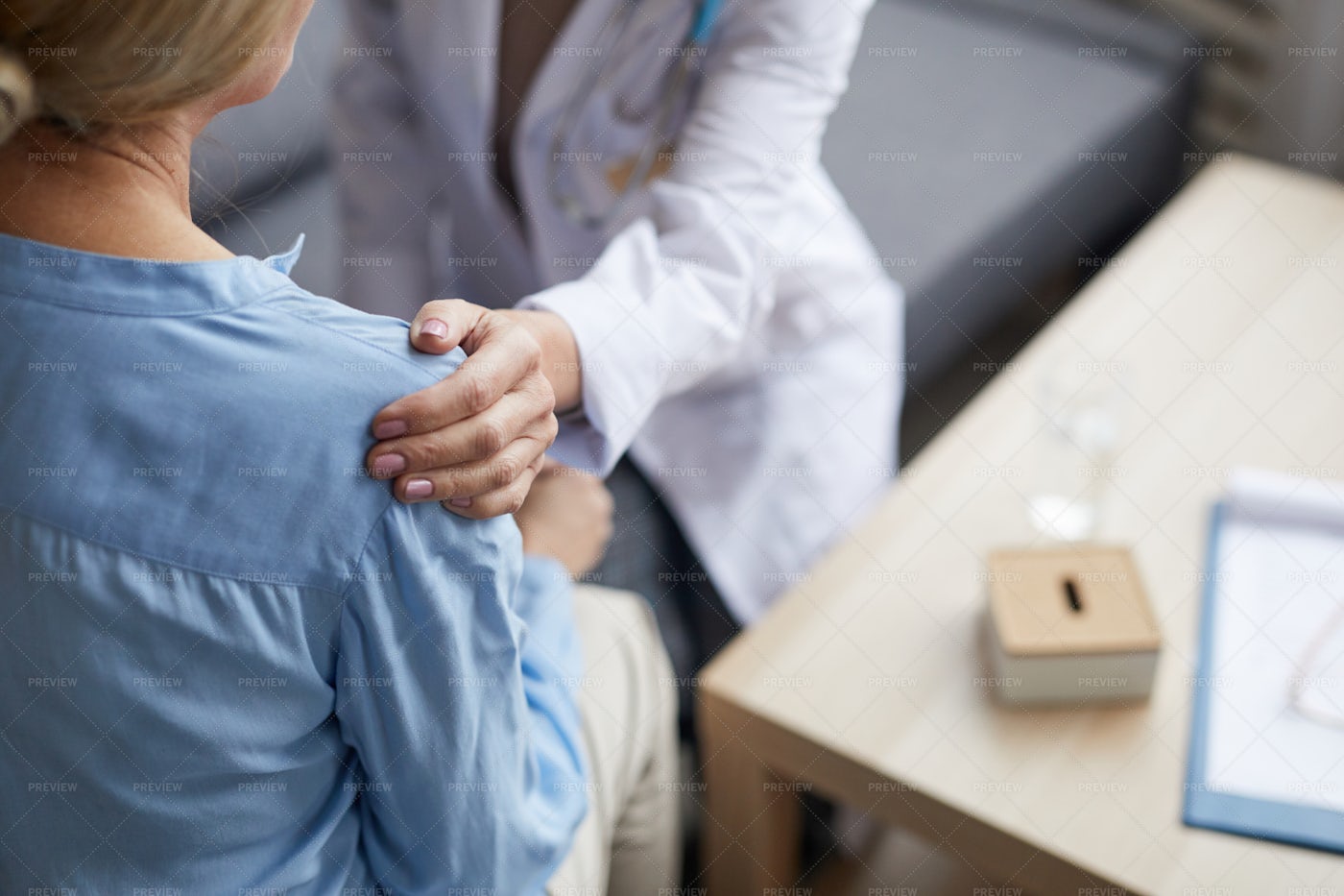 Female Doctor Comforting Patient: Stock Photos