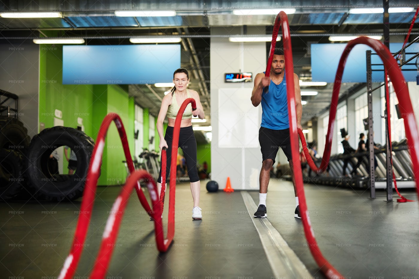 Couple Working Out With Battle...: Stock Photos
