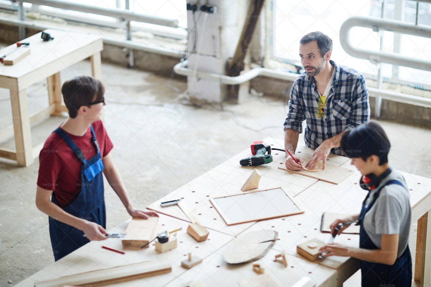 Carpenters Chatting While Working: Stock Photos