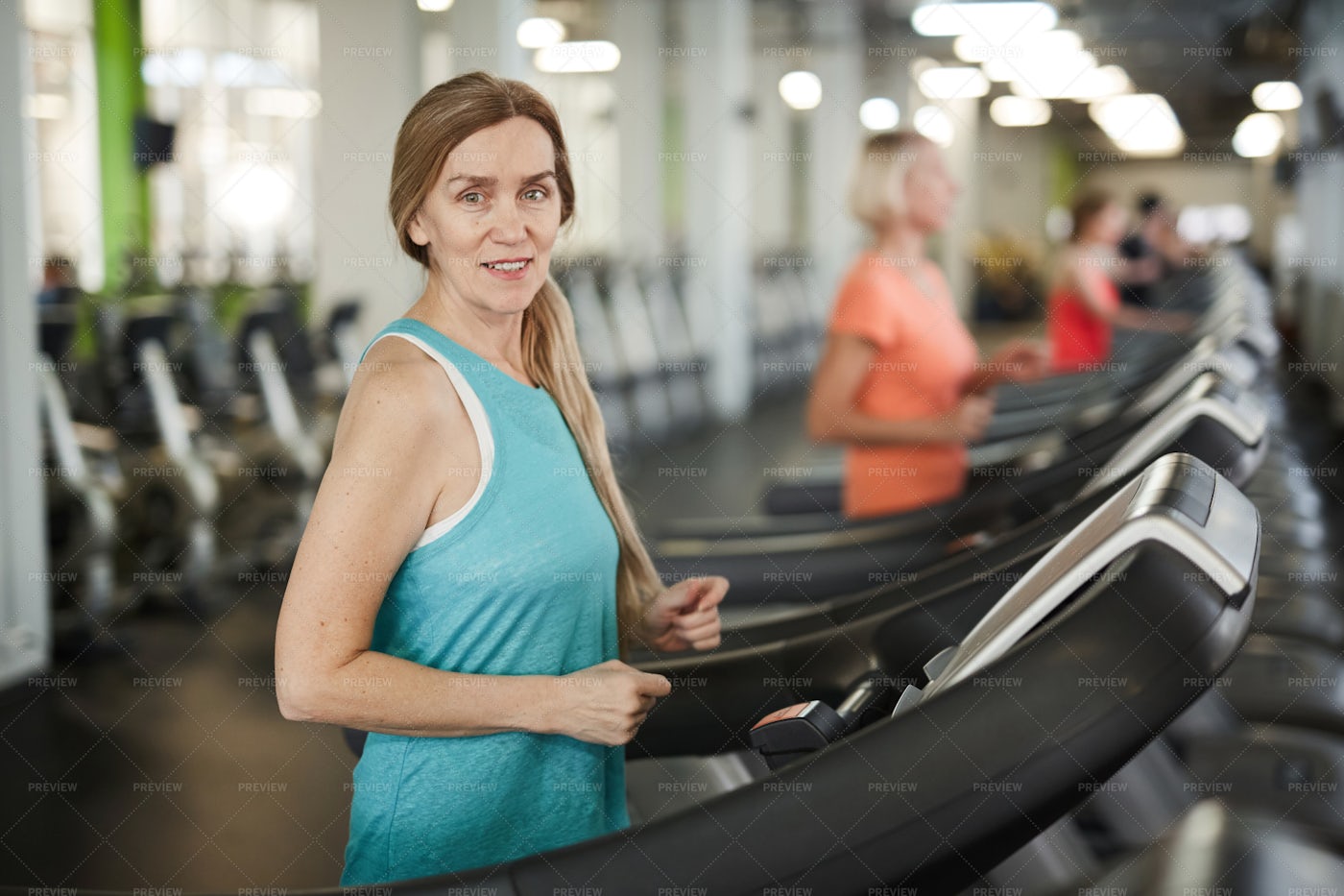 Mature Woman Running On Treadmill: Stock Photos