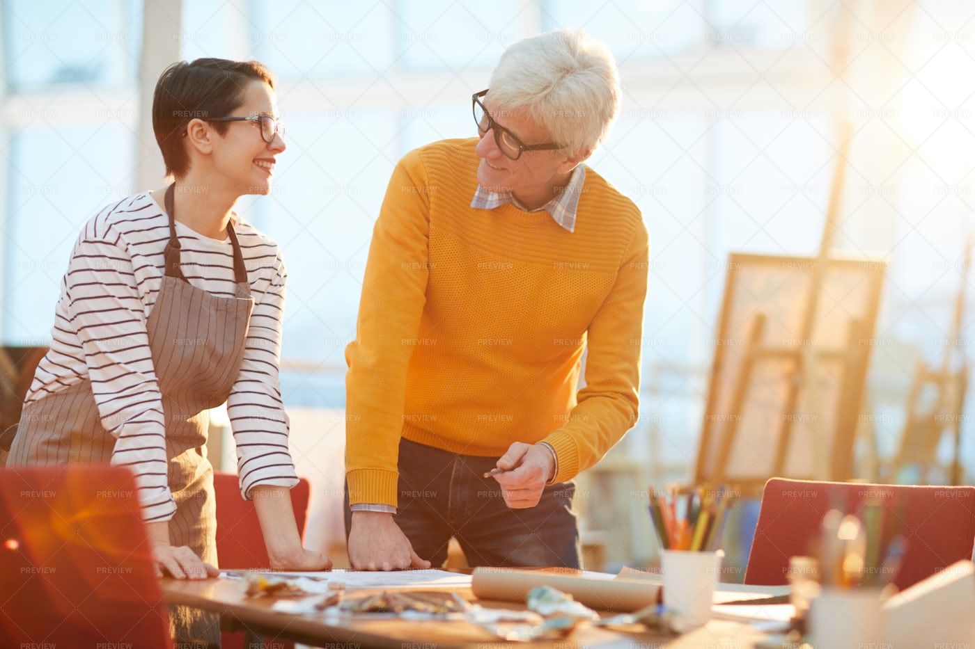 Senior Art Teacher Works With Student: Stock Photos
