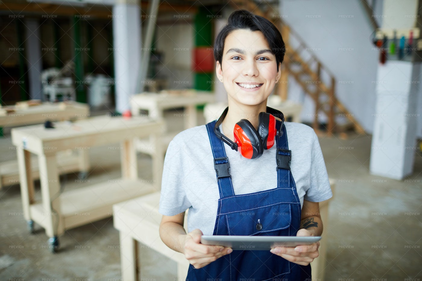 Smiling Female Carpenter With Tablet: Stock Photos