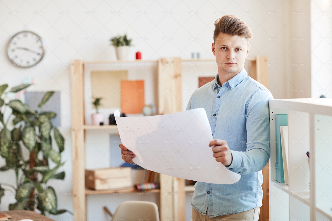 Young Architect Analyzing Blueprint: Stock Photos