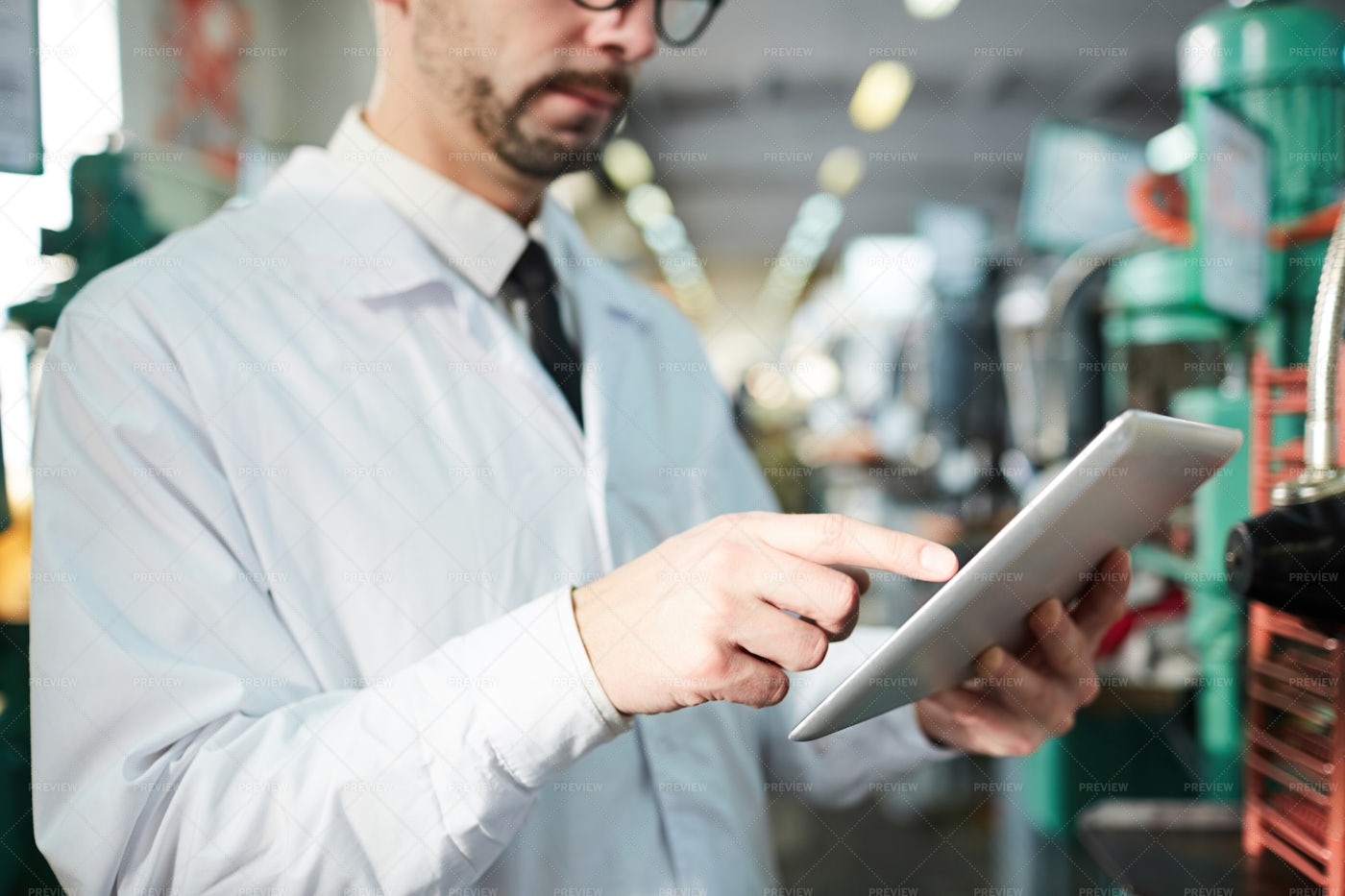 Factory Worker Holding Tablet: Stock Photos