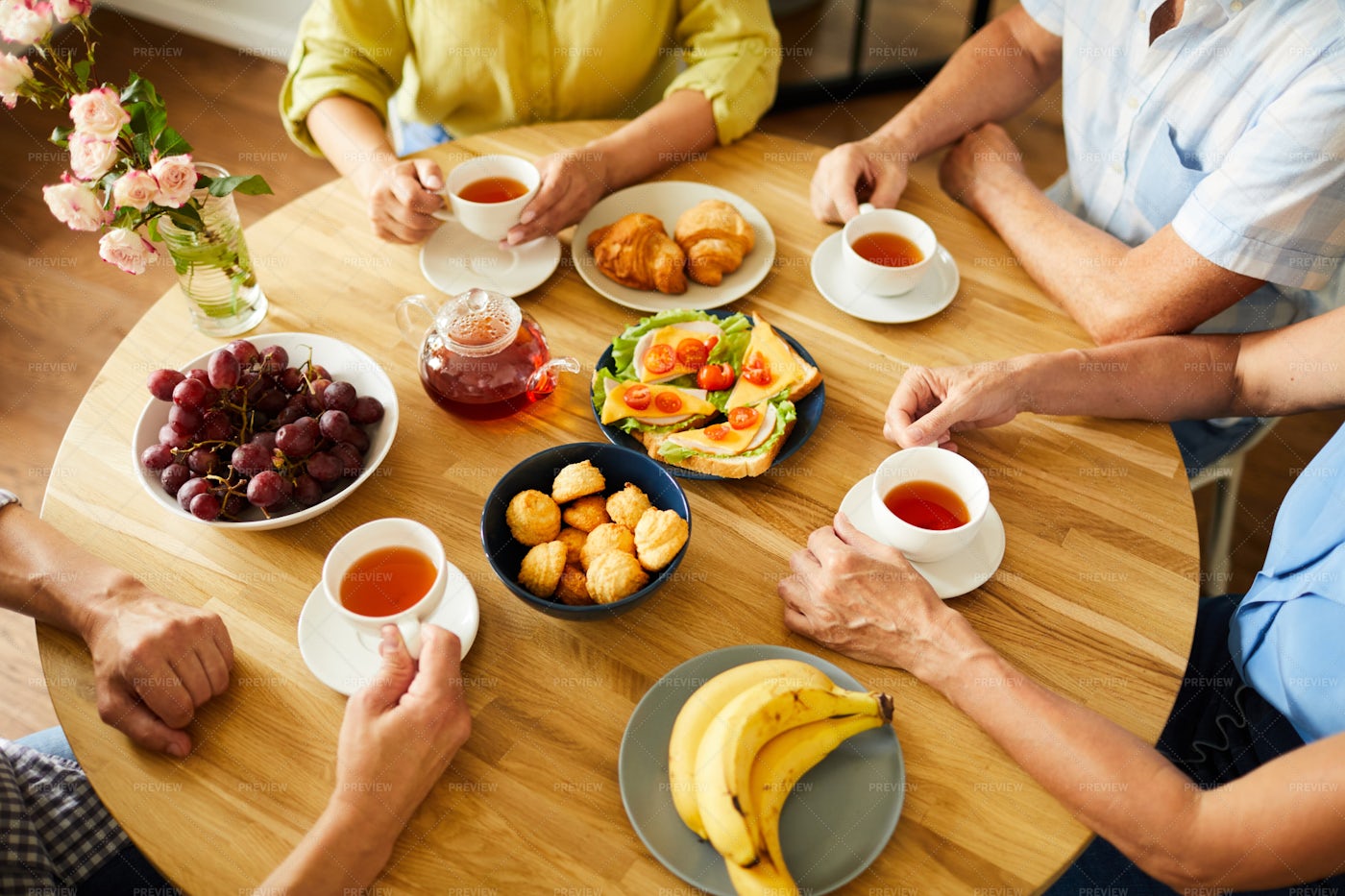 Friends At Round Table With Tea: Stock Photos