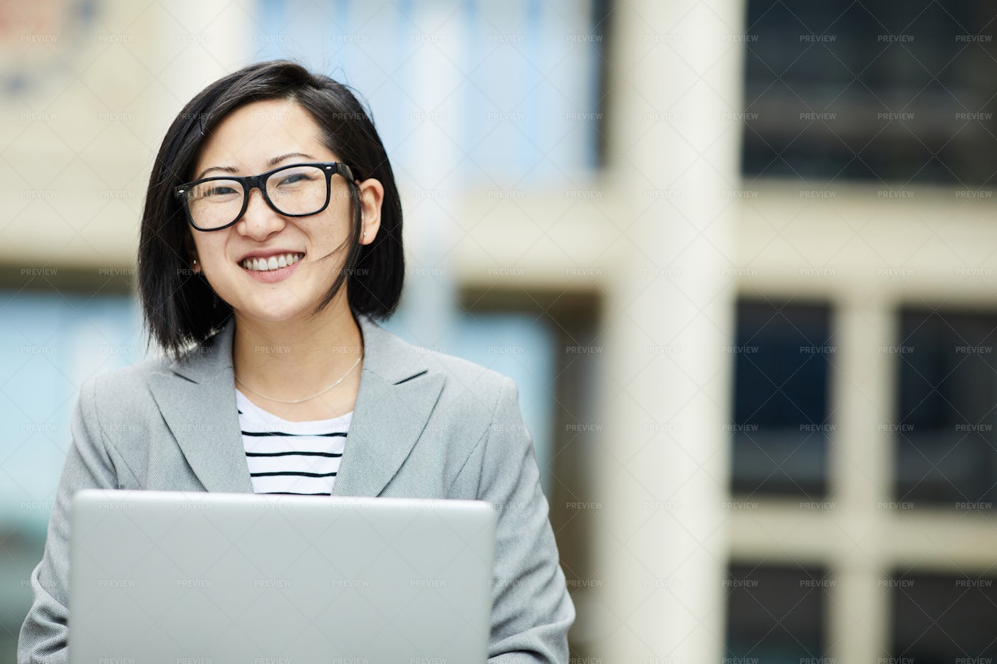 Young Asian Businesswoman Using...: Stock Photos