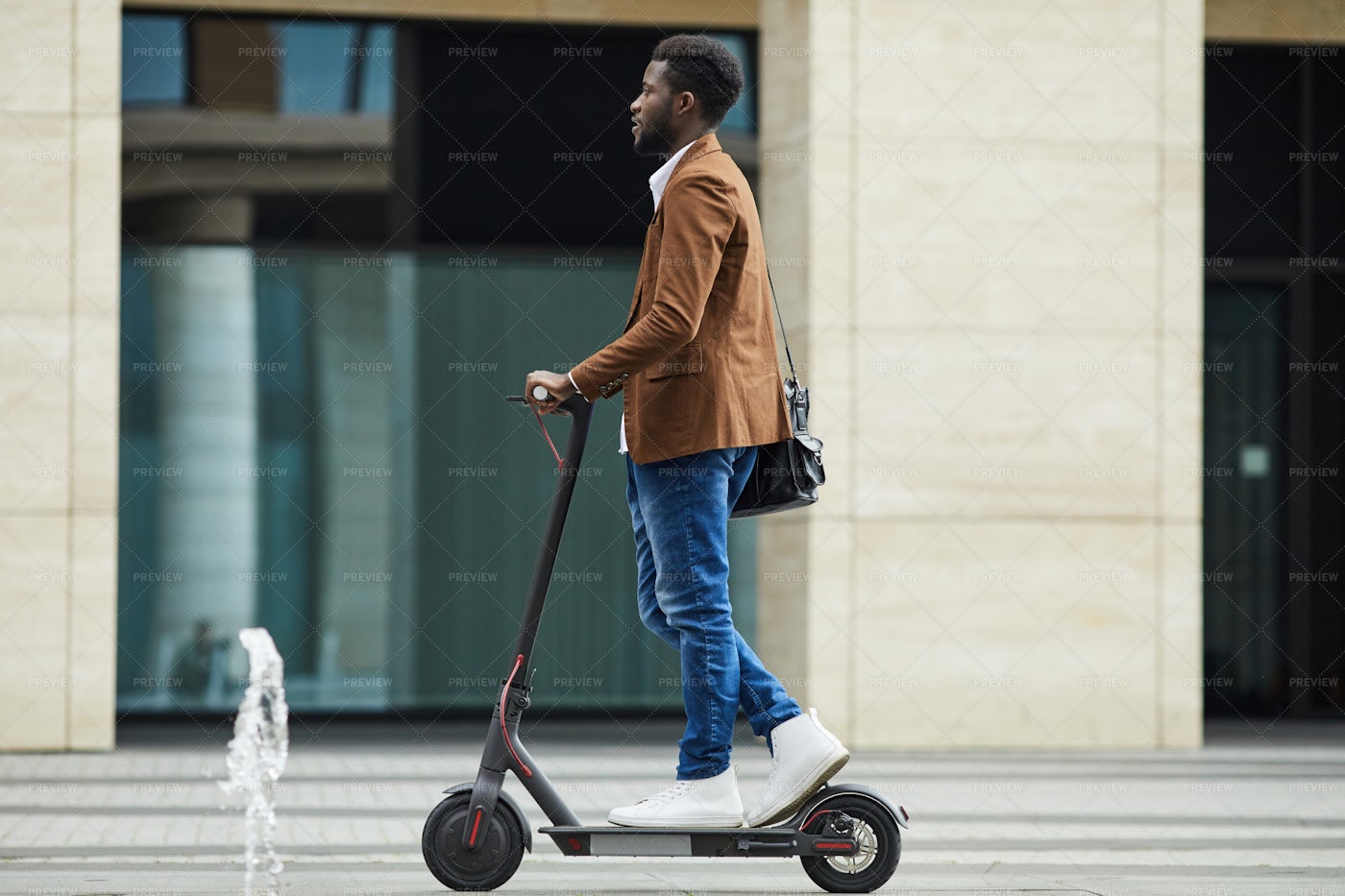 African Man Riding Electric Scooter...: Stock Photos