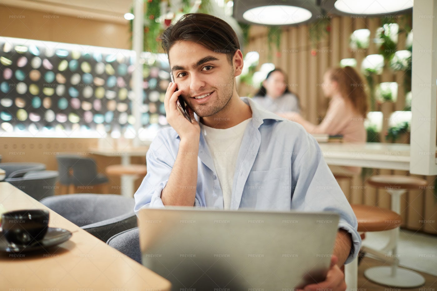 Mixed-Race Young Man Working In...: Stock Photos