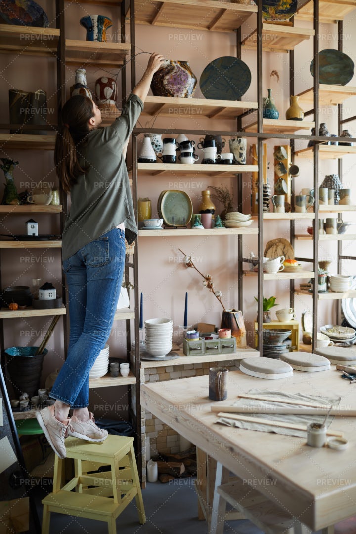 Woman Storing Ceramics On Shelf: Stock Photos