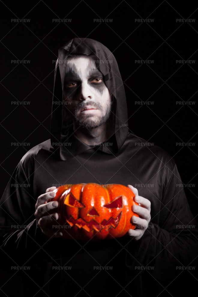 Grim Reaper Holds Pumpkin - Stock Photos | Motion Array