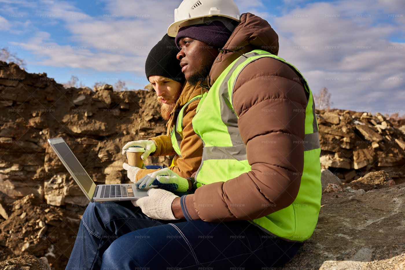 Miners Using Laptop On Excavation...: Stock Photos
