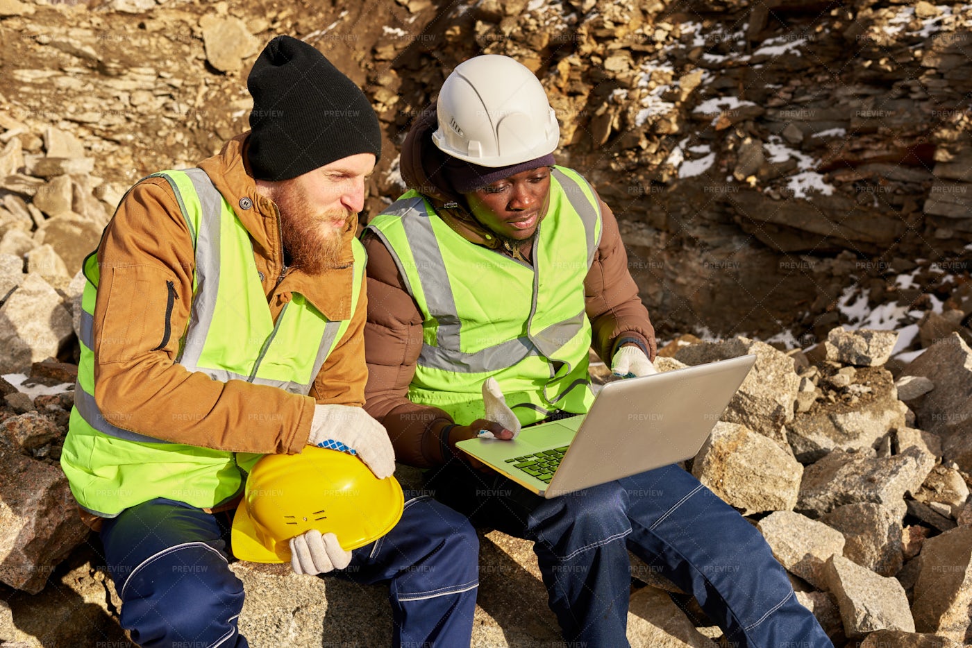 Miners Using Computer On Excavation...: Stock Photos