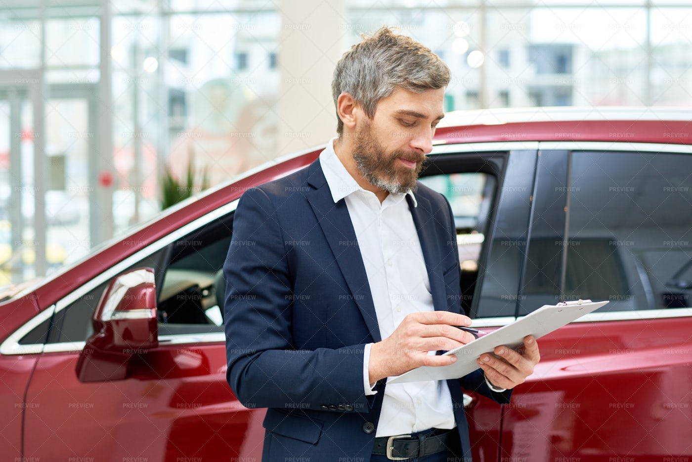 Mature Sales Assistant In Car...: Stock Photos